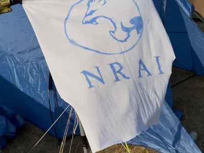 The Formula Student Newcastle Racing AI 2026 flag flying in the wind